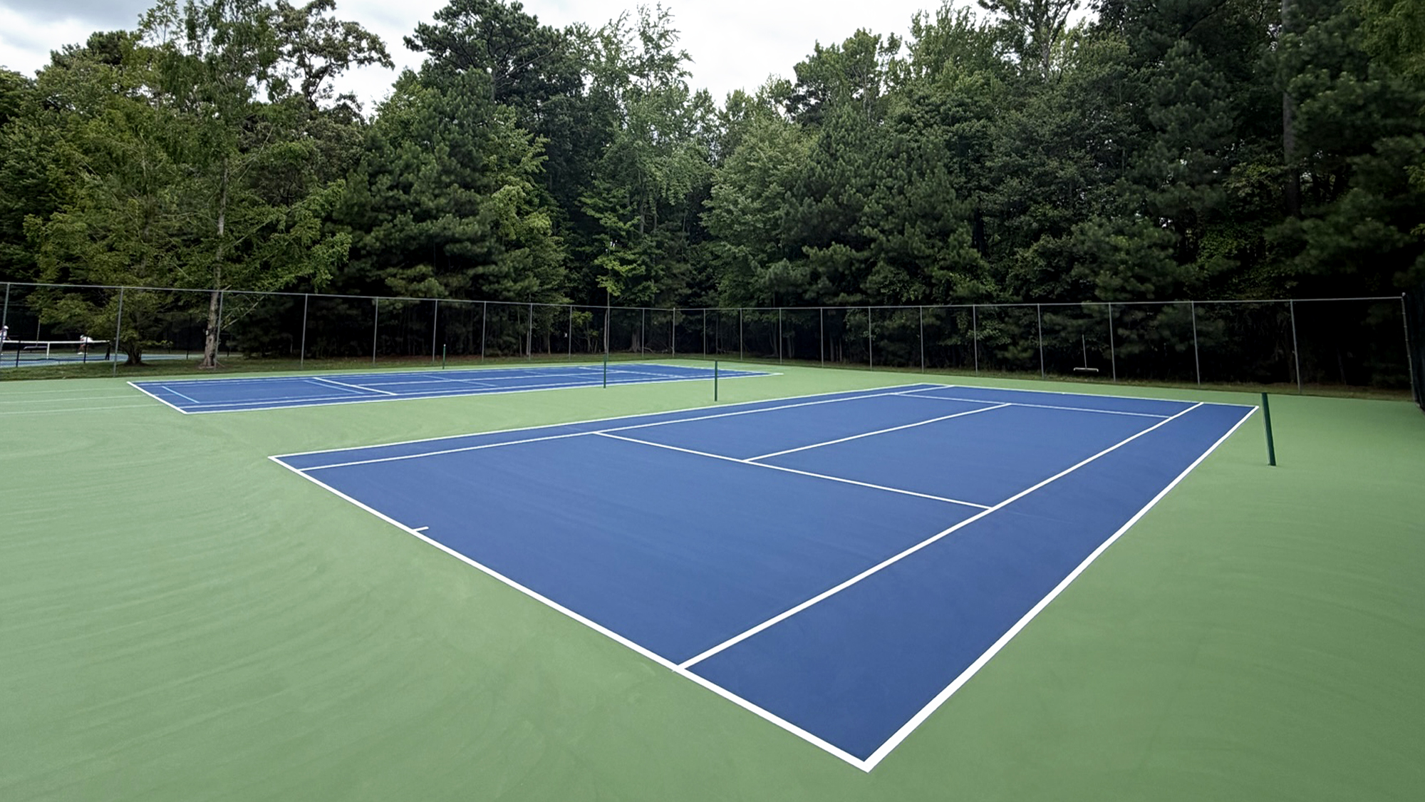 The Refuge tennis court viewed diagonally across the net